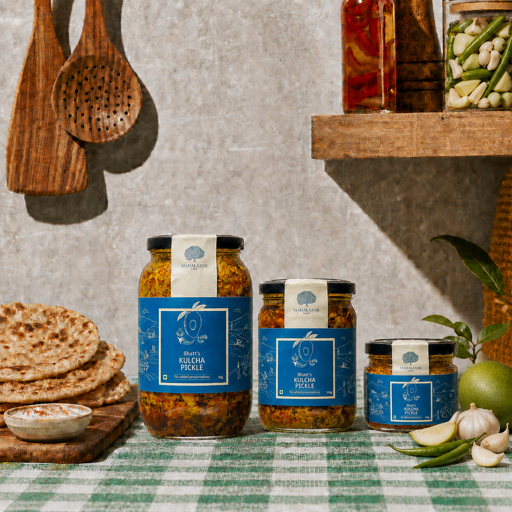 Three glass jars of spices arranged on a green-and-white checkered tablecloth with flatbread, garlic, and a lime in a rustic kitchen setting.