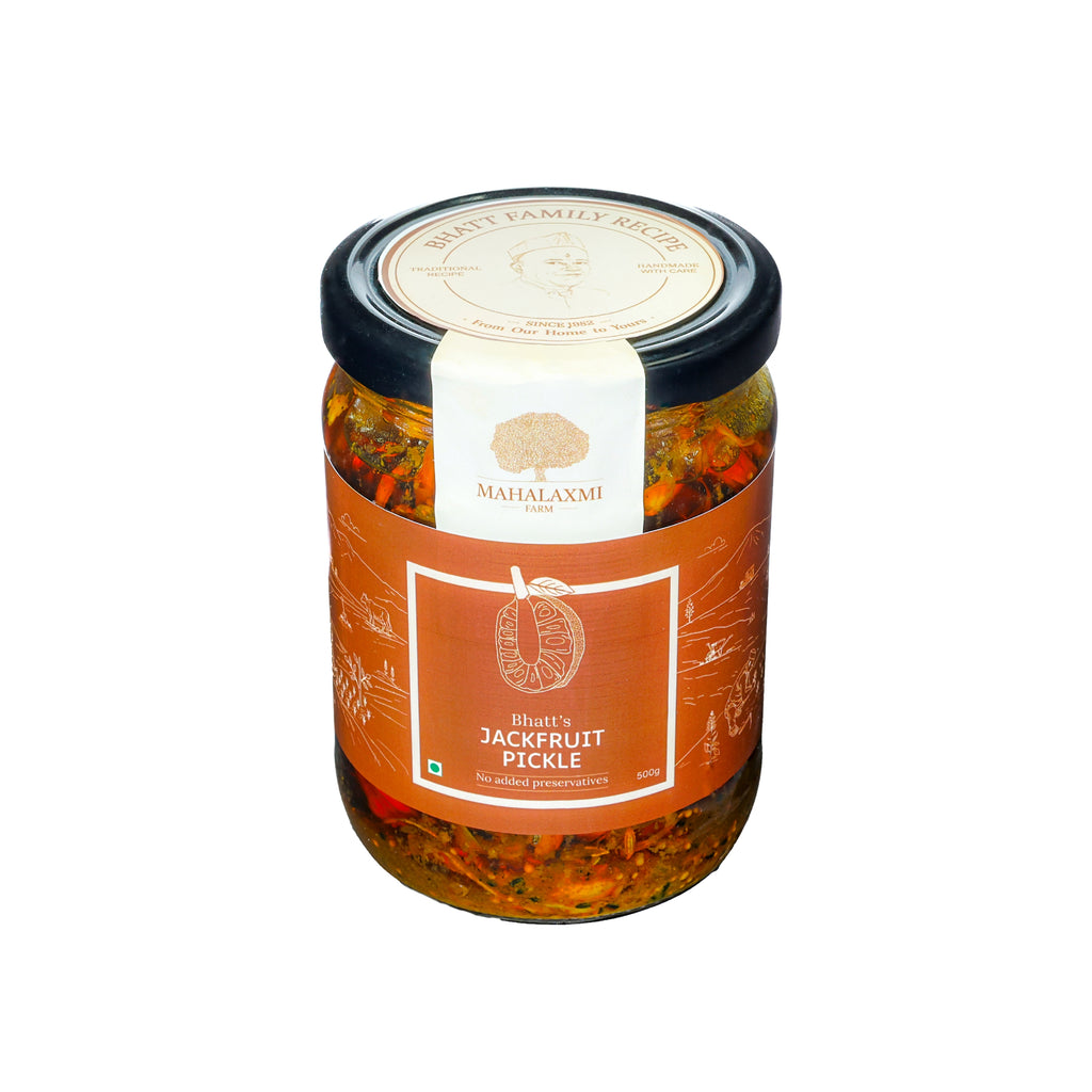 A glass jar of Mahalaxmi Farms 'Ethics Jackfruit Pickle' with a black lid and an orange label, set against a plain white background.